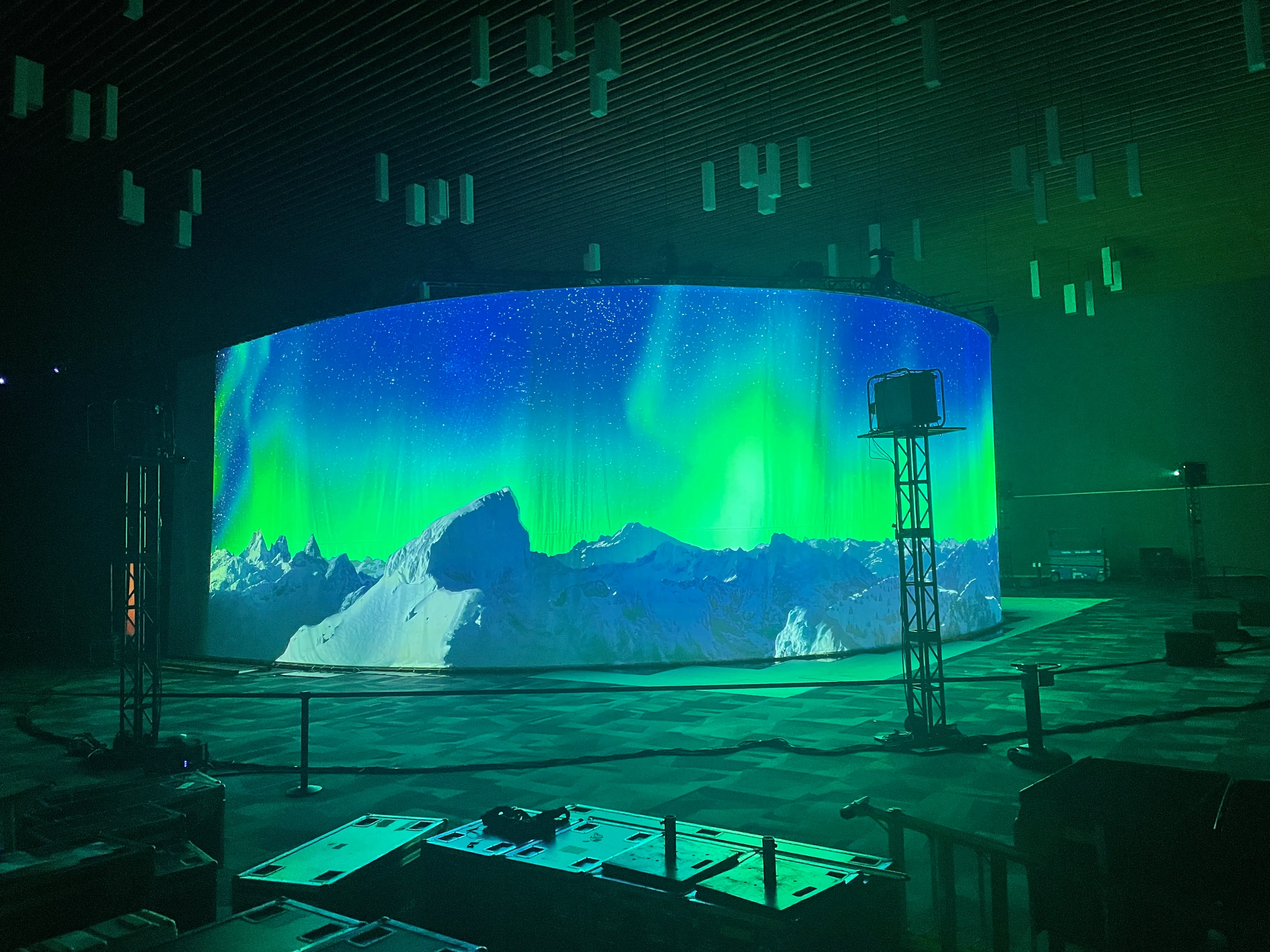 270-degree curved projection screen displaying aurora borealis over mountains at the Vancouver Convention Center for Arc'teryx